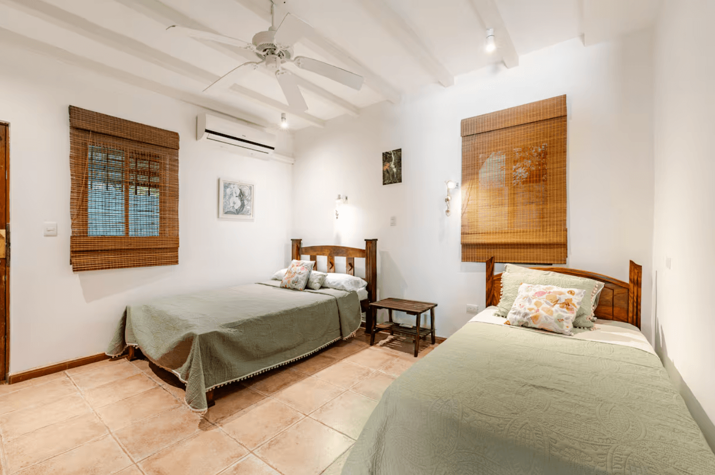 A bright double room designed for peaceful nights, blending handcrafted wood, soft linens, and cool mountain air drifting through the windows.