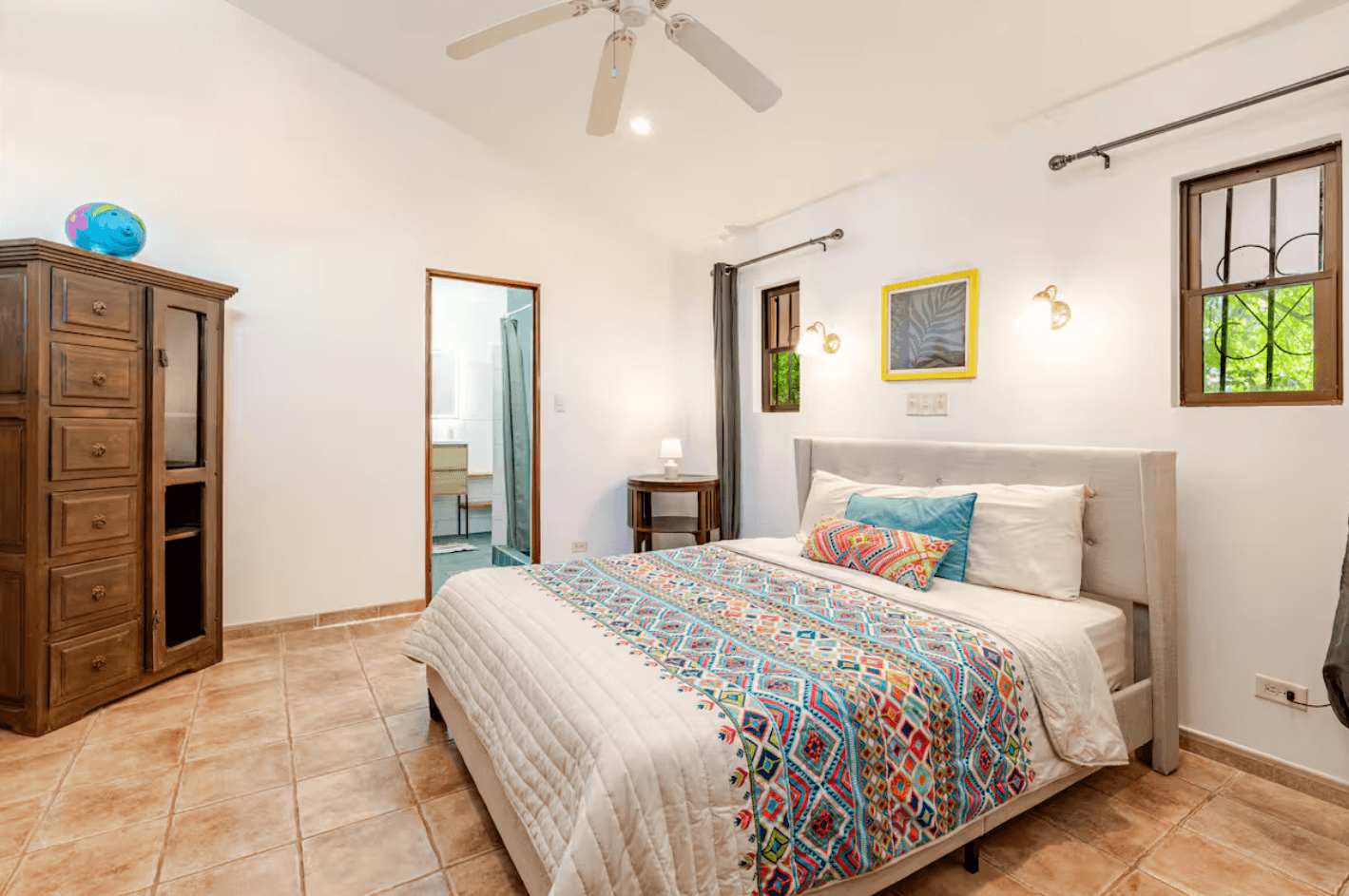 Bright and inviting bedroom with a queen bed, wooden accents, and serene jungle views, offering the perfect balance of comfort and character.