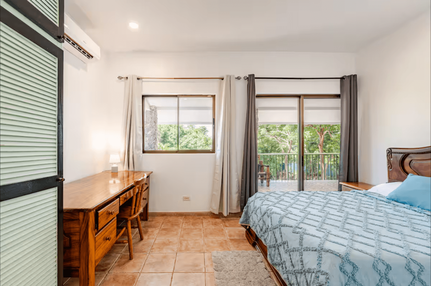 A clean and serene room offering privacy, comfort, and gentle daylight, designed for travelers who appreciate tranquil, uncluttered spaces.