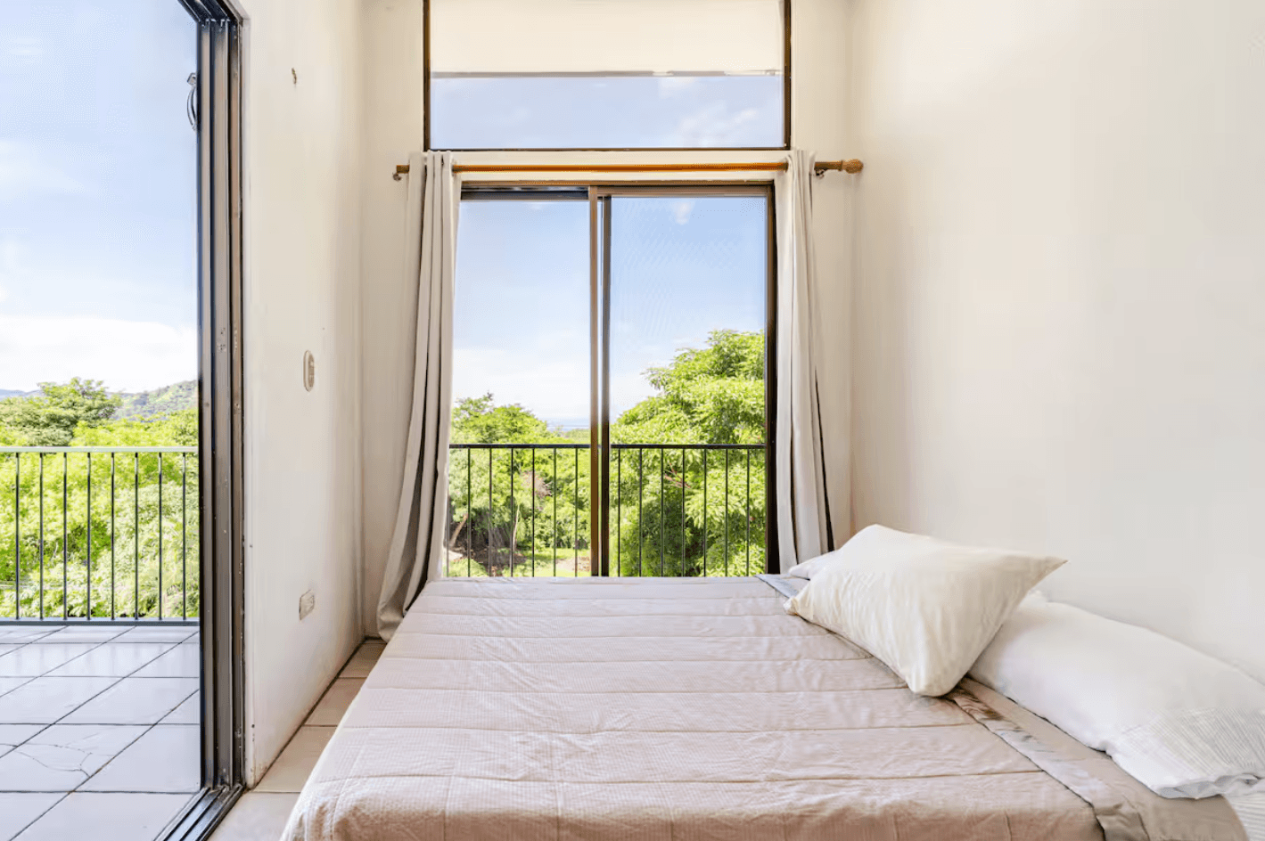 A bright, modern room with its own private terrace, offering calming views of the surrounding hills, perfect for guests who love fresh air and natural light.