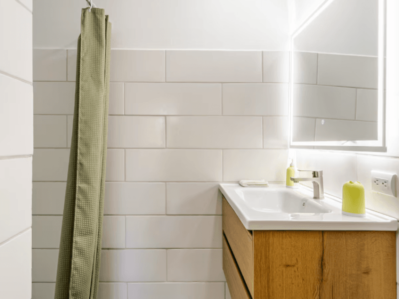 A bright and spotless bathroom with a practical walk-in shower, ideal for quick, refreshing moments throughout your stay.