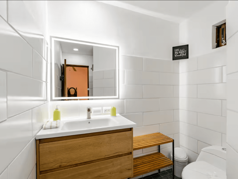 A stylish bathroom with bright lighting, a clean walk-in shower, and a contemporary vanity — perfect for a refreshing start to your day.