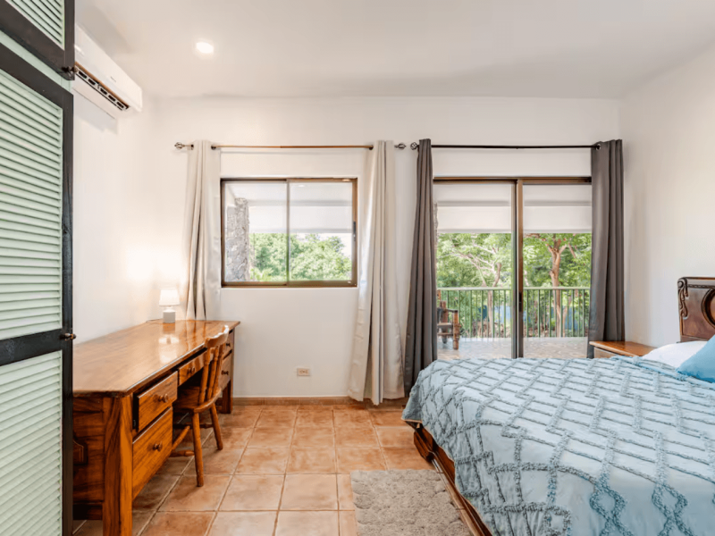 A clean and serene room offering privacy, comfort, and gentle daylight, designed for travelers who appreciate tranquil, uncluttered spaces.