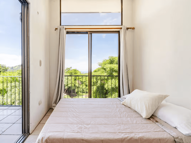 A bright, modern room with its own private terrace, offering calming views of the surrounding hills, perfect for guests who love fresh air and natural light.